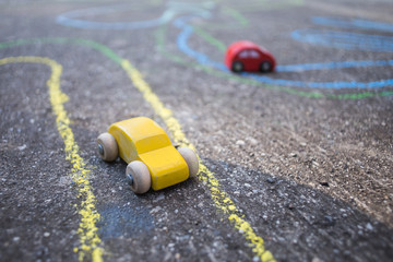 Naklejka na ściany i meble small toy yellow and red cars on the playground