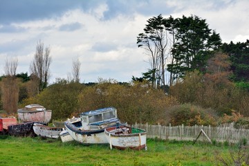 Fototapeta premium Old little boats at seaside in Brittany. France