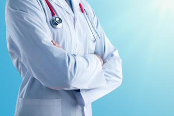 Young doctor with a stethoscope shows stop sign with his hands