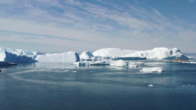 4K Aerial Drone shot of Iceberg and ice from glacier in arctic nature landscape on Greenland. Aerial video drone footage of icebergs in Ilulissat icefjord. Affected by climate change and global warmin