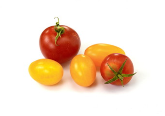 Cherry red and yellow tomatoes isolated over white background.