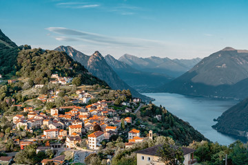 Naklejka na ściany i meble View of Swiss village bre sopra and Lugano Lake before sunset from Monte Bre in Lugano