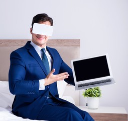 Businessman wearing a virtual reality headset in the bedroom