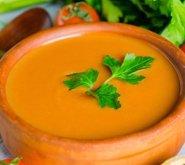 The pumpkin soup served on the table in bowl