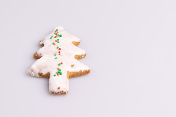 Christmas Ginger and Honey cookie. Gingerbread cookie in tree shape isolated on white background.