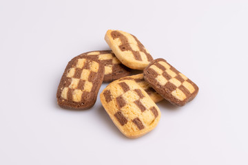 Home made cookies with chocolate, butter and vanilla, isolated on white background, soft light, angle view, copy space