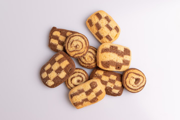 Home made cookies with chocolate, butter and vanilla, isolated on white background, soft light, angle view, copy space
