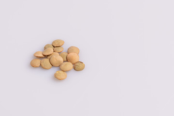 Dry uncooked lentils isolated on white background, copy space, studio shot, soft light. Christmas and New Year dish
