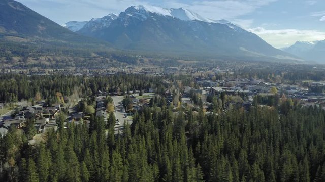 Aerial flying over the town of Canmore near Banff. The town is surrounded by the Canadian Rocky Mountains. Alberta, Canada. 