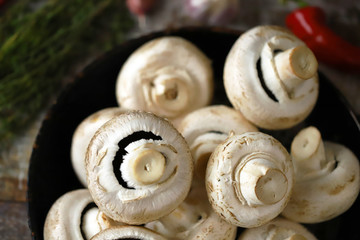 Fototapeta na wymiar Raw champignons with thyme, chili pepper and spices. Selective focus. Macro.