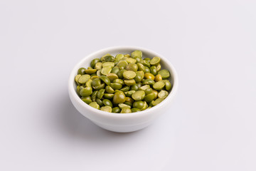 Split dried uncooked peas isolated on white background, close-up, studio shot, soft light, copy space. Christmas dish