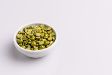 Split dried uncooked peas isolated on white background, close-up, studio shot, soft light, copy space. Christmas dish