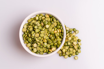 Split dried uncooked peas isolated on white background, close-up, studio shot, soft light, copy space. Christmas dish