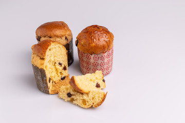 Traditional Christmas mini Panettone with raisins and dried fruits. Christmas mini cake panettone isolated on white background, soft light