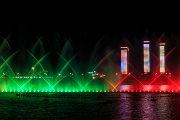 Music fountain on the water at night