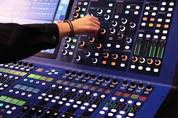 sound engineer working with digital mixing console