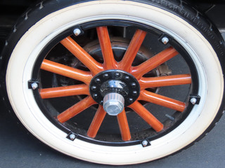 Antique car wheel seated in vehicle docking place