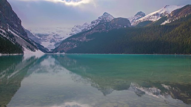 People canoeing Lake Louise and Mountains in the winter near Banff Alberta, Canada. 