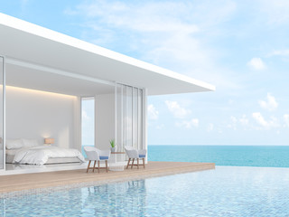 A white villa in minimal style with a sliding open overlooking the bedroom. In front of the bedroom is a wooden balcony and swimming pool. That overlooks the sea - 3d render