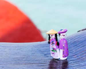 Magnetic wooden puppets dolls souvenirs with boat and ocean background