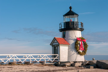 Fototapeta na wymiar Brand Point Lighthouse, located on Nantucket Island in Massachusetts, decorated for the holidays with a Christmas wreath and crossed oars.