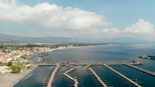 Aerial, large empty marina with misaligned pontoons, Marina di Riposto, Italy