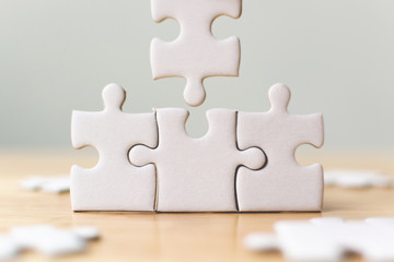 White jigsaw puzzle connecting together. Team business success partnership or teamwork concept