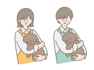 子犬を抱っこするペットショップの店員さん
