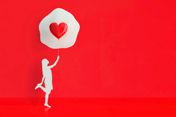 young woman standing holding balloon Heart shape.