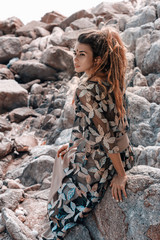 beautiful young woman with feathers in hair outdoors close up portrait