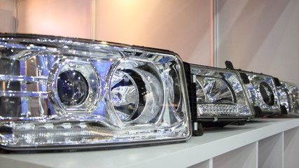 Car headlamps device close up, frontlight head lights spare parts on stand