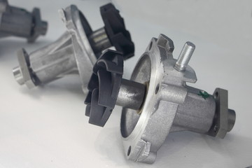 New car water pumps with impeller blades close up on white background