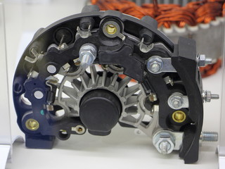 Car alternator diode bridge elimenator close up on stator coil background
