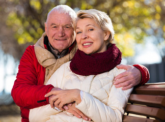 Mature couple sitting in park