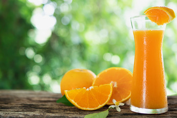 Fresh juicy orange fruit set over green nature background - tropical orange fruit for background use