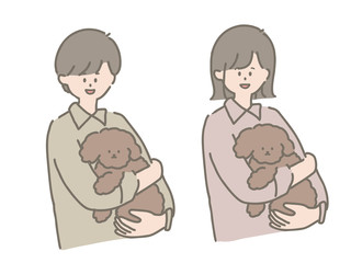 トイプードルを抱っこする男の子と女の子