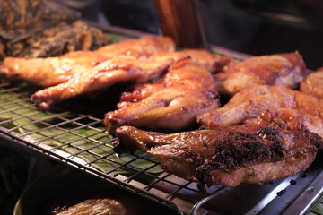 Grilled chicken on steel grating