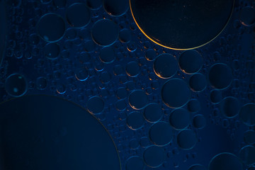 Air bubbles in the water background.Abstract oxygen bubbles in the sea.Circle foamy air in the ocean.Water bubbles isolate on blue background. - obrazy, fototapety, plakaty