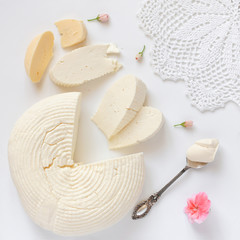 homemade cheese, butter and cream on white background. Square format