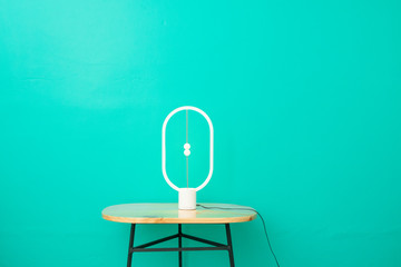minimalist photograph of lamp on wooden table