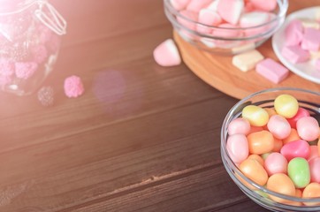 multi-colored candies in a plate, bank and bowls, close up