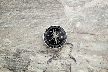 Fototapeta na wymiar Compass - small and stylish - on grey background top view copy space