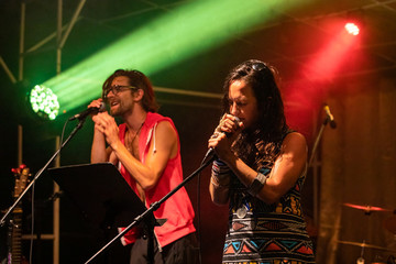 woman and man are singing and on the stage, male and female two singers performing during live...