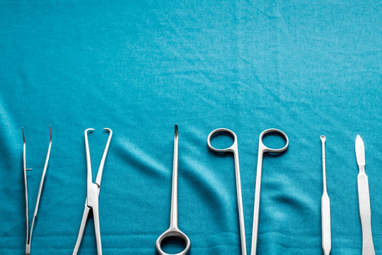 Instruments for plastic surgery on blue background flat lay