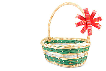 Fototapeta na wymiar Empty wicker basket with red ribbon isolated on white background
