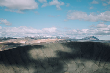 View of Hverfjall volcanic crater near Myvatn, Iceland in the summer with mountains in the...