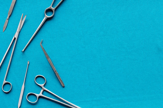 Plastic Surgery. Instruments For Beauty Operations On Blue Background Top View Frame Copy Space