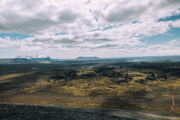 View of Hverfjall lava field near Myvatn, Iceland in the summer with volcanos in the background