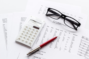 Naklejka na ściany i meble Taxes calculation concept. Financial documents, calculator, glasses on white background