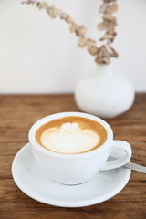 cappuccino or Latte art coffee made from milk on the wood table in coffee shop